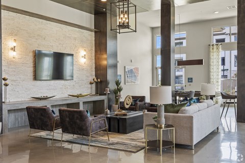 a living room with couches and chairs and a television